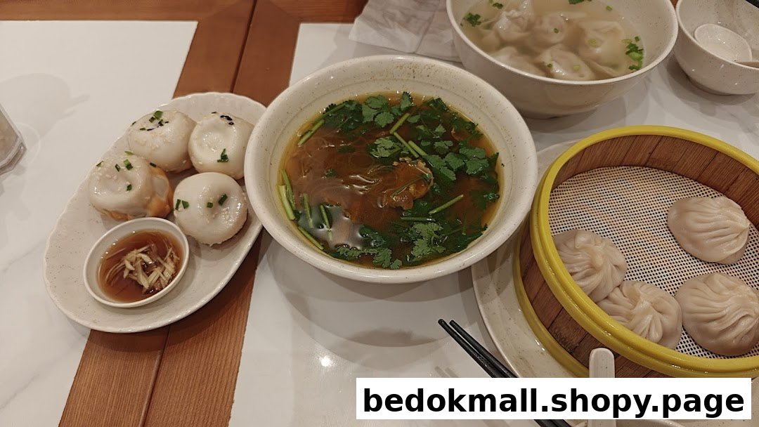 Table with pan-fried buns, soup, and steamed dumplings.