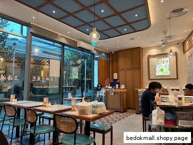 Interior view of a restaurant with tables, chairs, and a service counter.