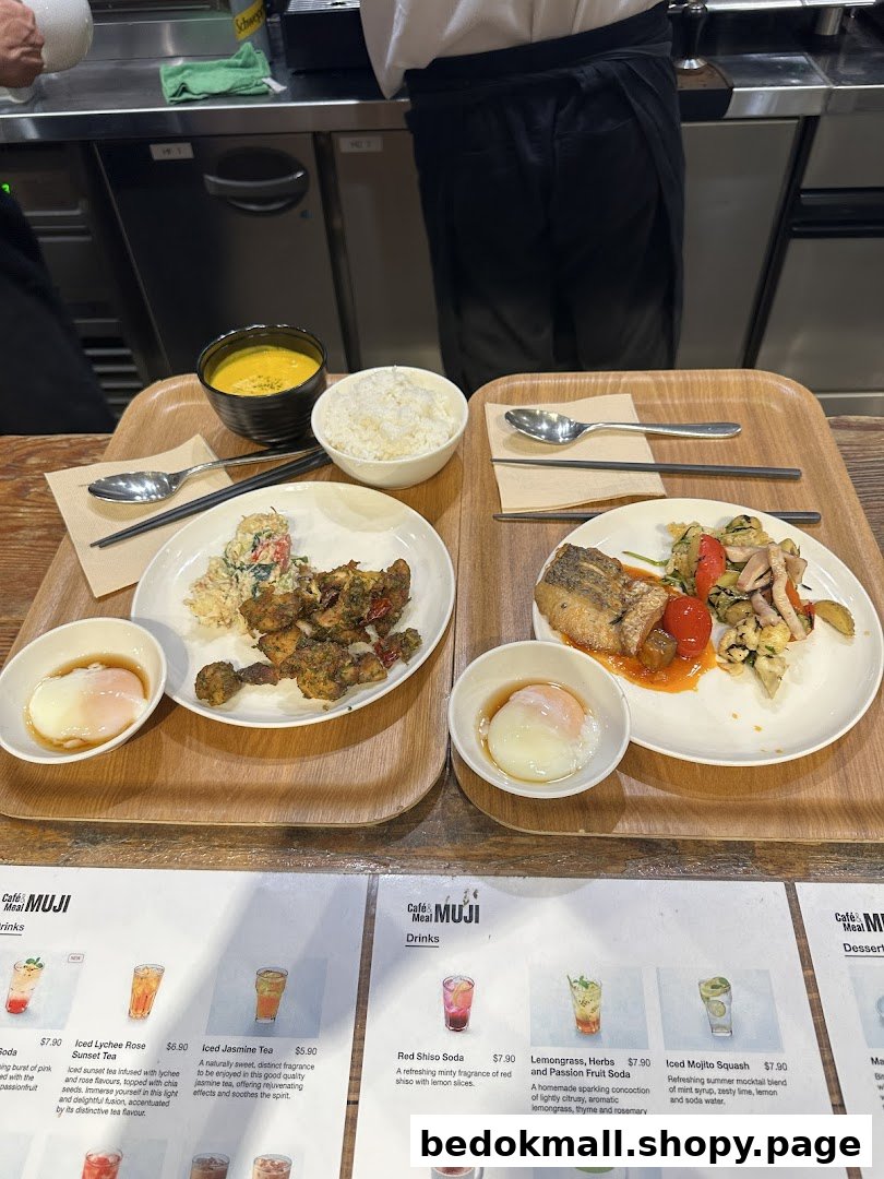 Two meals on trays with drinks menu visible in the foreground.