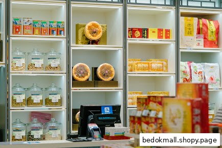 Shelves filled with various packaged products and jars of dried goods in a retail shop.