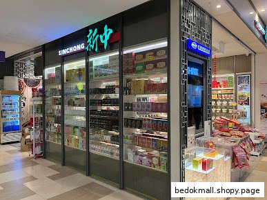 Shop front with display windows full of products and prominent signage.
