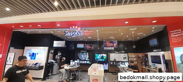 Interior of a Singtel retail shop with product displays and people.