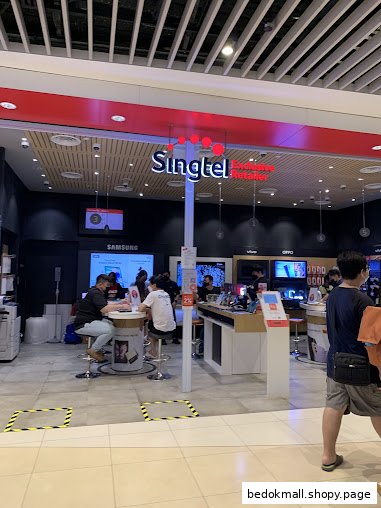 The image shows the entrance of a Singtel retail shop with customers inside.