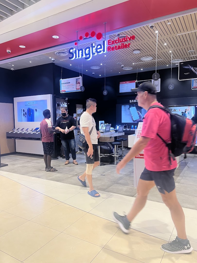 People walk past the entrance of a Singtel Exclusive Retailer shop.