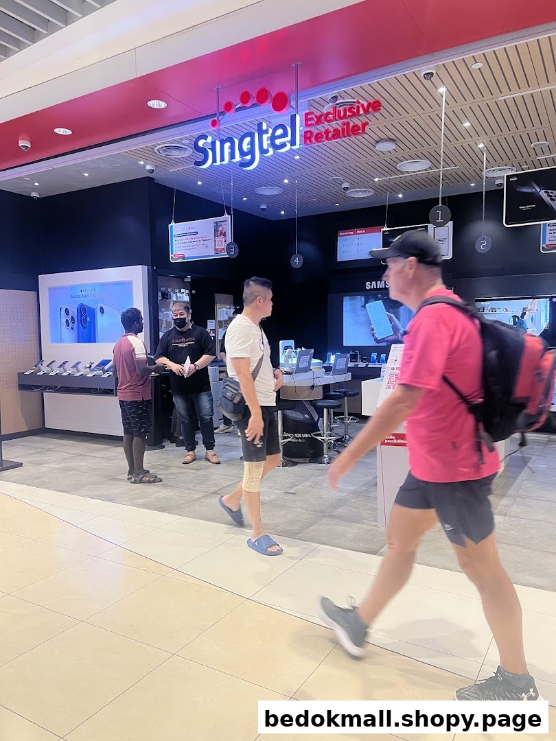 People walk past the entrance of a Singtel Exclusive Retailer shop.
