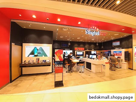 Singtel shop entrance with product displays and customers inside.