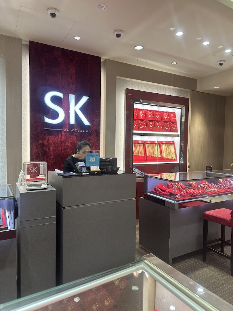 Interior view of a jewellery shop with staff and display cases.