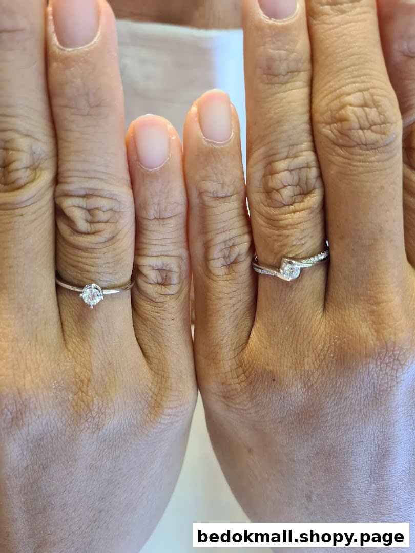 Two hands wearing diamond rings.