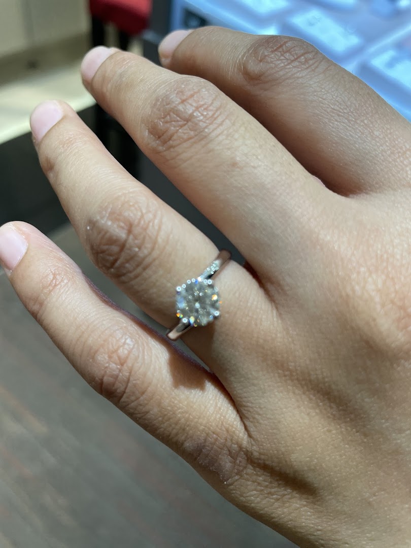 Close-up of a hand wearing a large diamond ring.