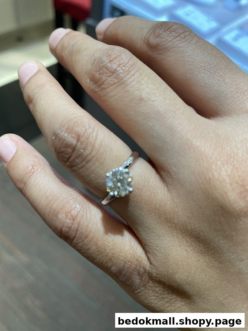 Close-up of a hand wearing a large diamond ring.