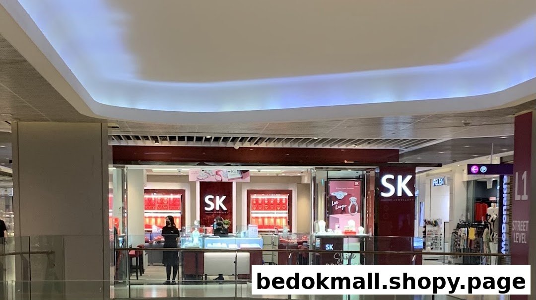 SK Jewellery shop front in a mall with jewelry displays and staff inside.