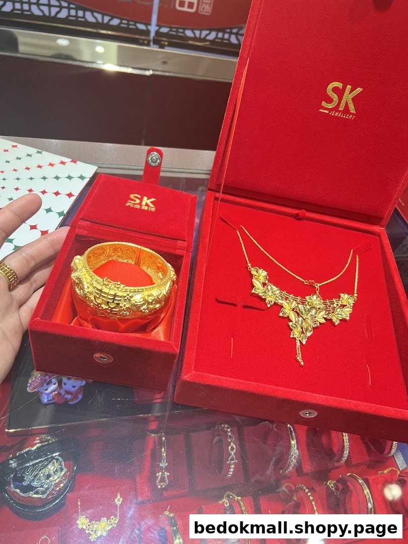 Gold jewelry in red velvet boxes displayed in a shop.