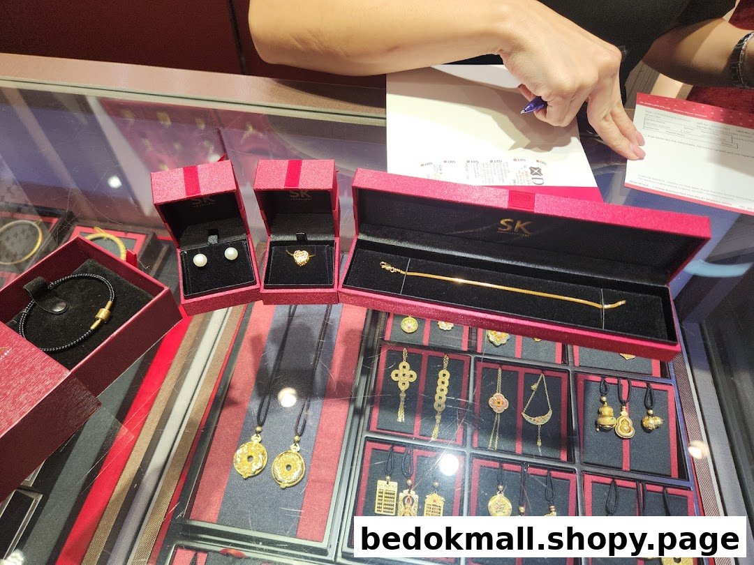 Jewelry display with red boxes and a person's hand filling a form.