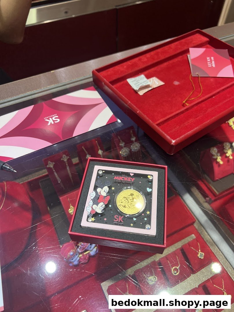 Interior view of a jewellery shop display with a Mickey Mouse gold coin.