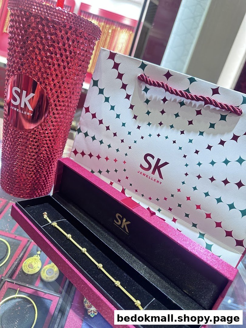 Gold bracelet in box with SK Jewellery bag and tumbler.