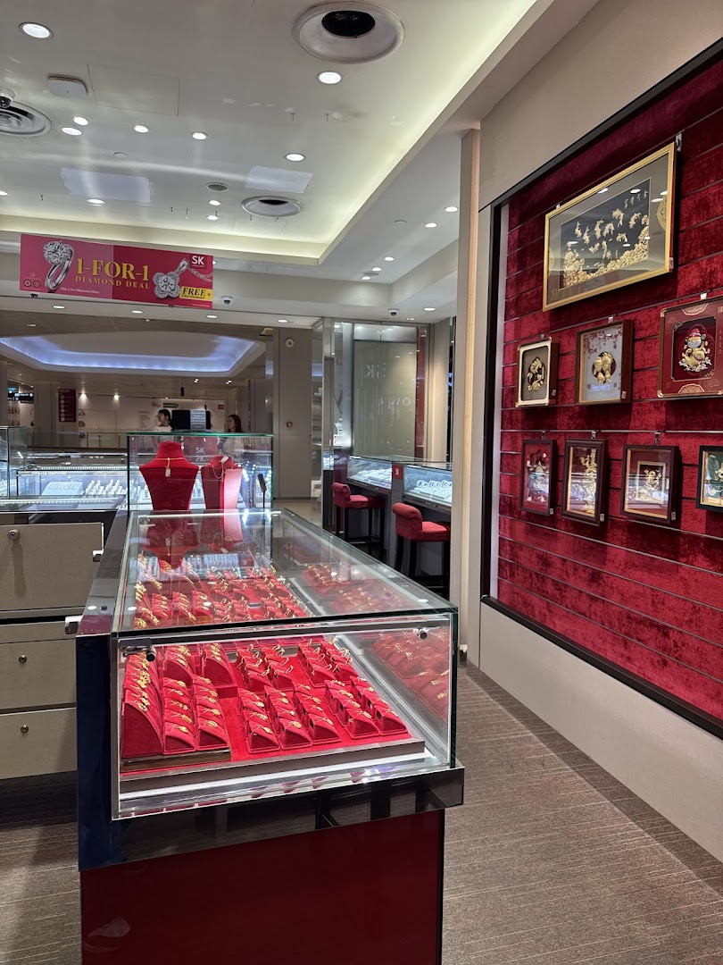 Interior view of a jewellery shop with display cases and a red velvet wall.