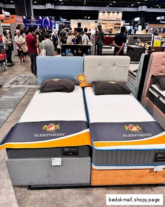 Two SLEEPNIGHT mattresses displayed in a retail or exhibition setting.