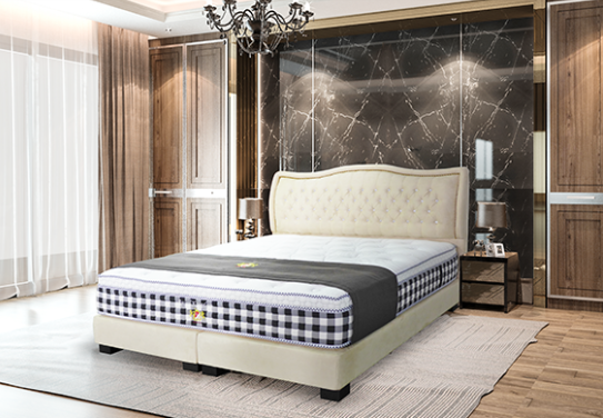 A bed with a mattress and headboard in a bedroom setting.