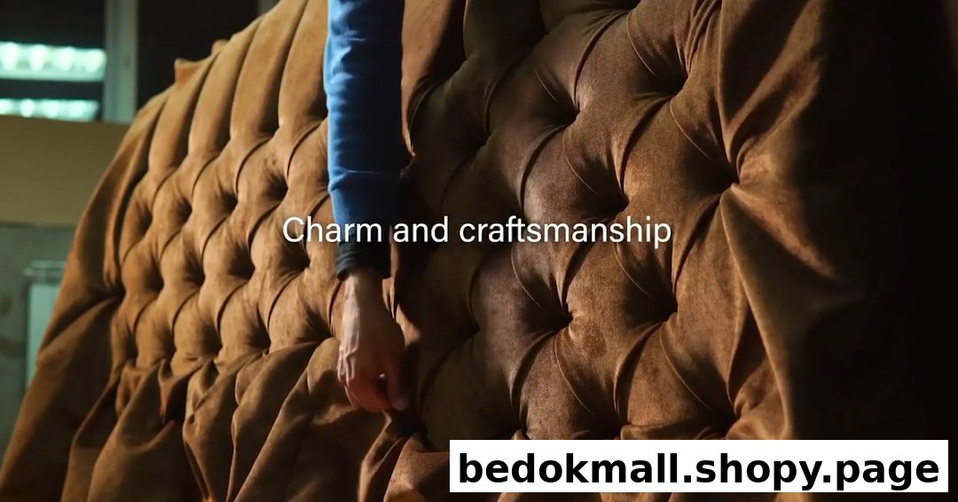 Close-up of tufted brown upholstery with a person's arm touching it.
