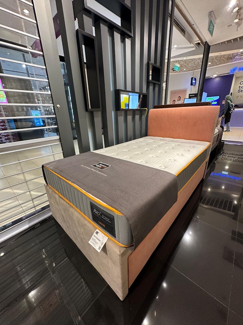 Mattress and bed frame on display in a retail shop.