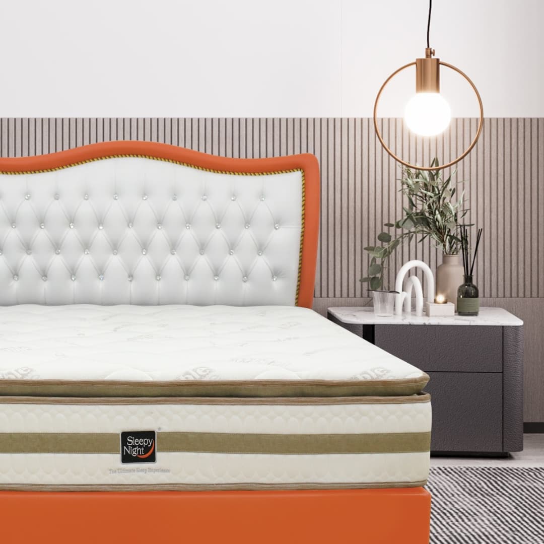 A Sleepy Night mattress on a bed with a white tufted headboard and nightstand.