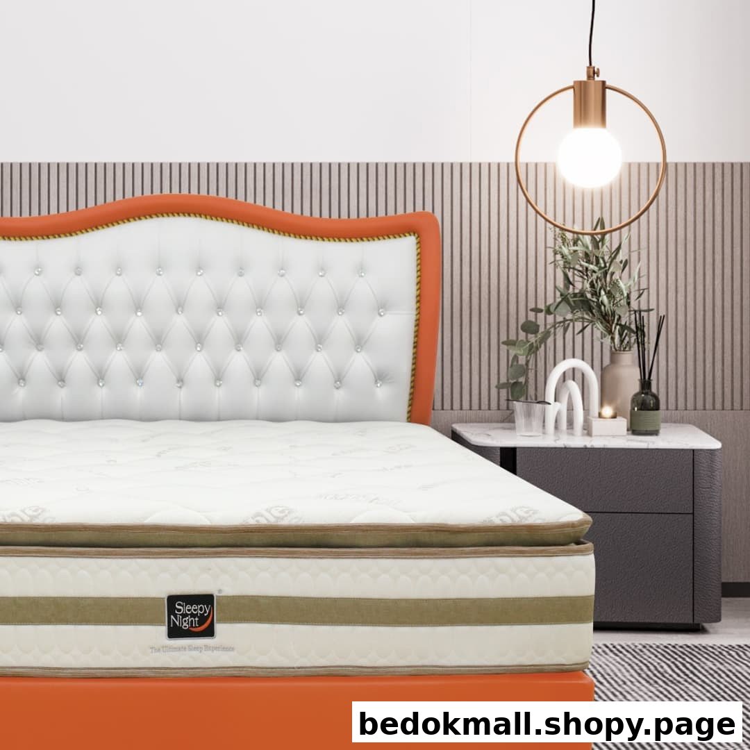 A Sleepy Night mattress on a bed with a white tufted headboard and nightstand.