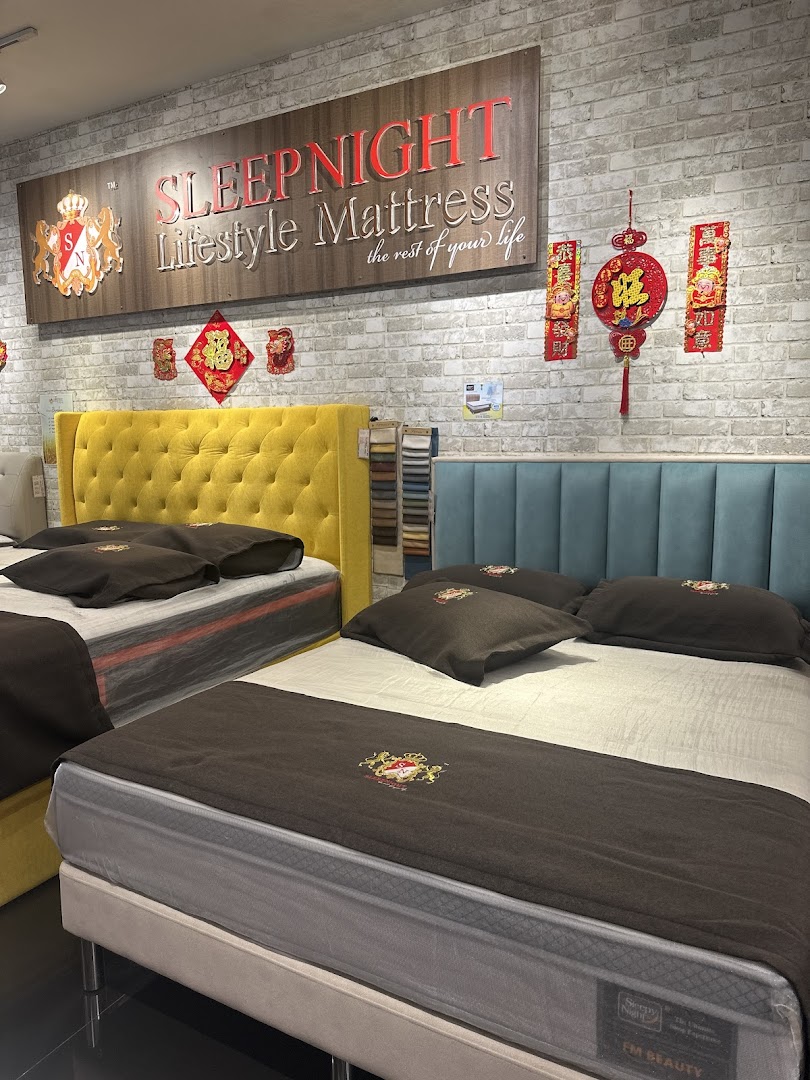 Interior view of a mattress shop with beds on display and Sleepnight branding.