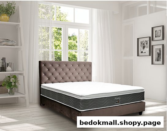 A bed with a mattress and tufted headboard in a bright room.