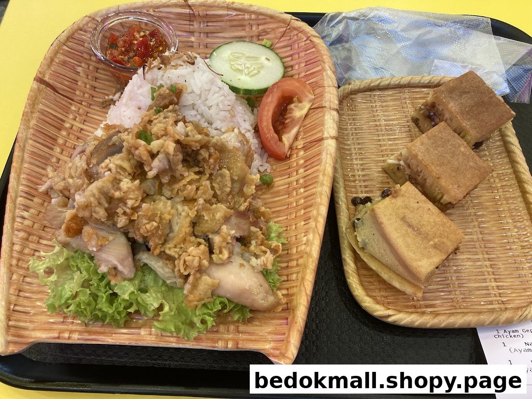 Rice with fried chicken and martabak served on woven trays.