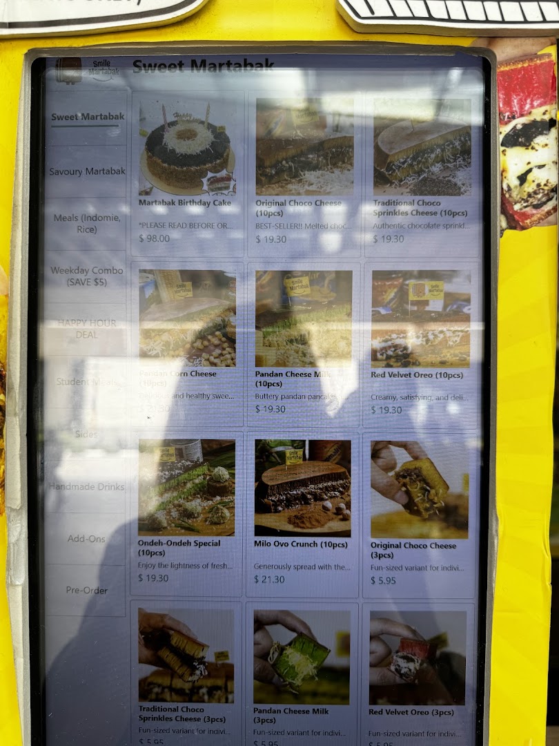A digital menu display showing various martabak products with prices and images.