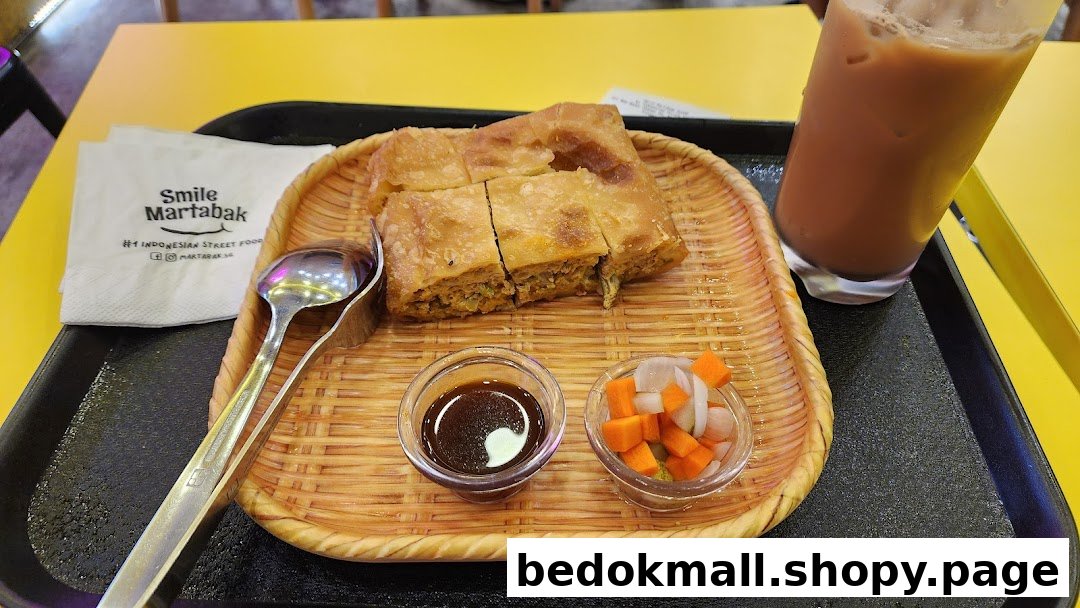 Martabak, drink, and condiments served on a tray.
