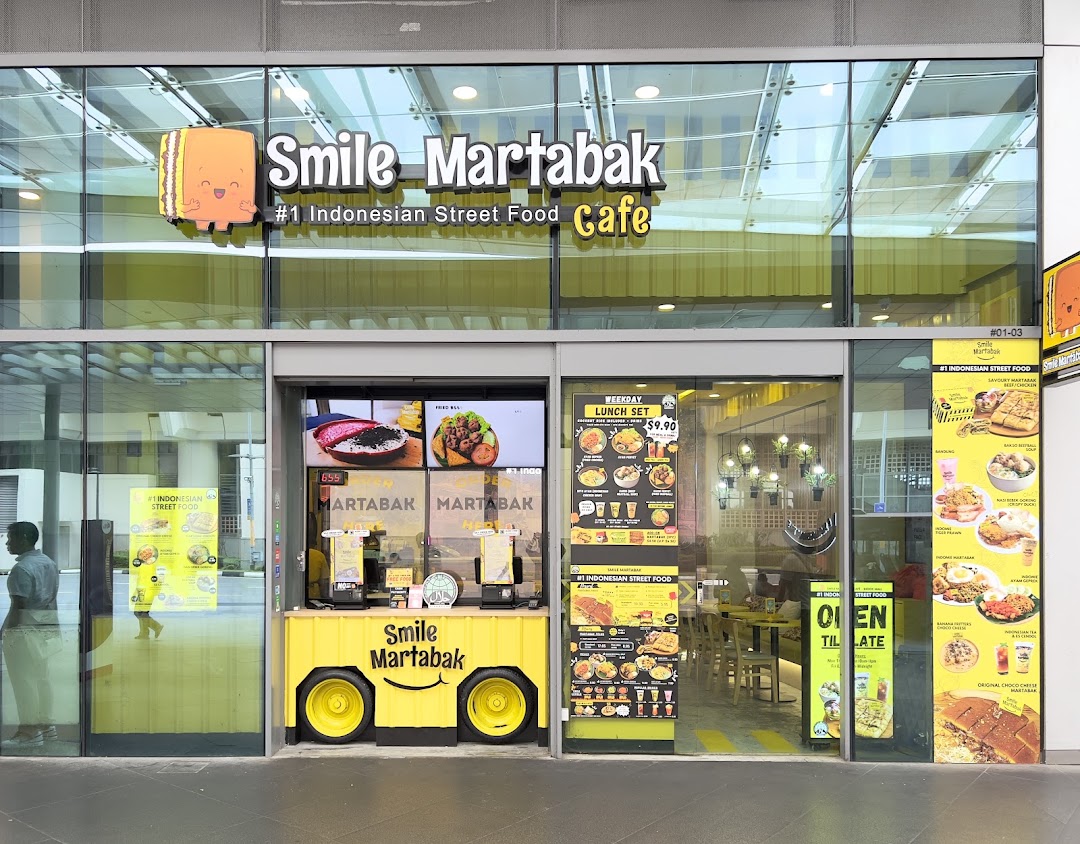 Shop front of Smile Martabak Café with signage and food displays.