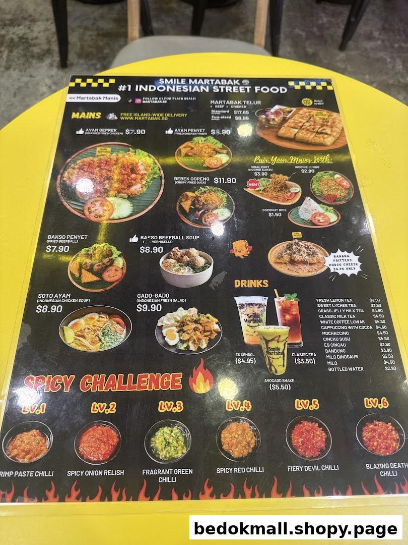 A laminated menu displaying Indonesian street food, drinks, and spicy chili options.