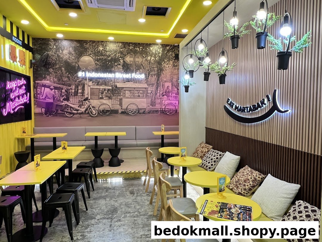 Brightly lit cafe interior with yellow tables, banquette seating, and wall murals.
