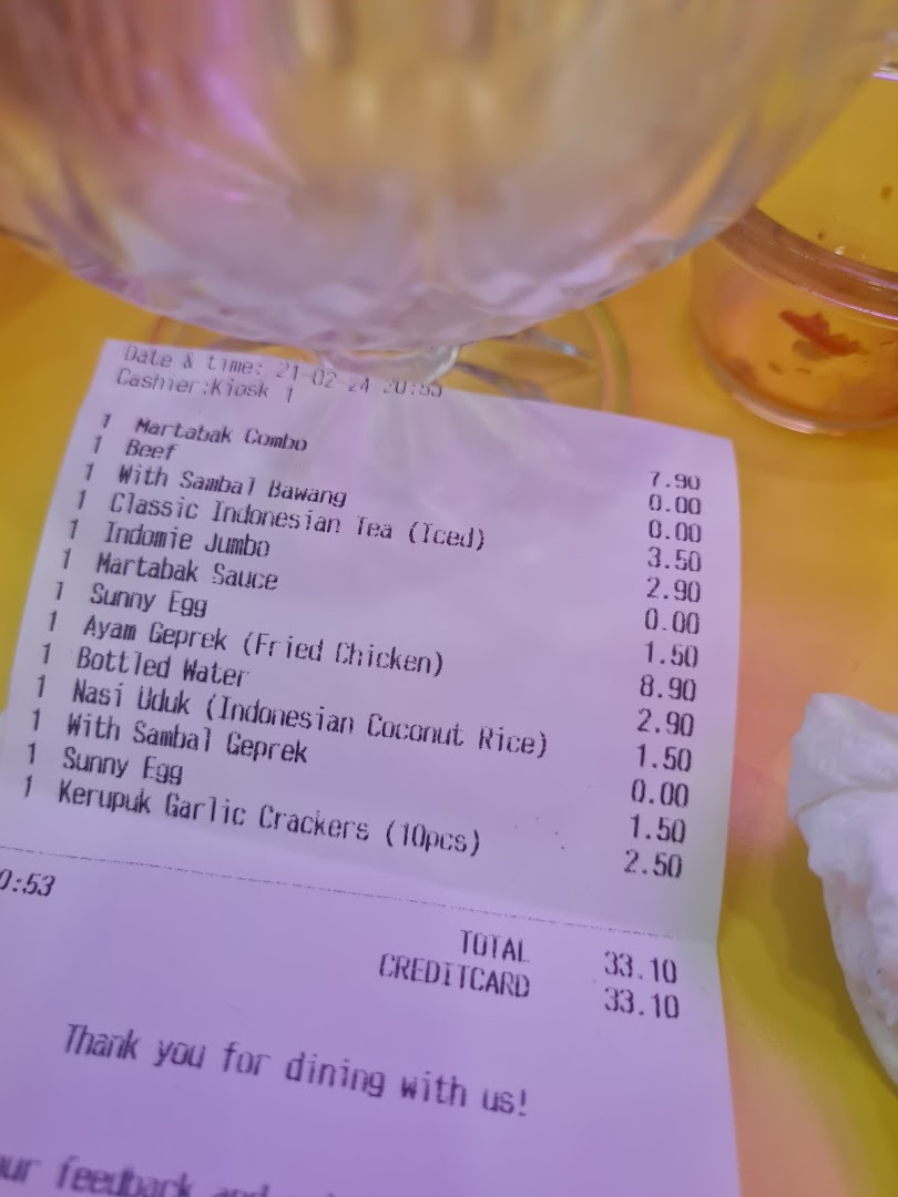 A printed receipt from Smile Martabak Café showing food items and prices.