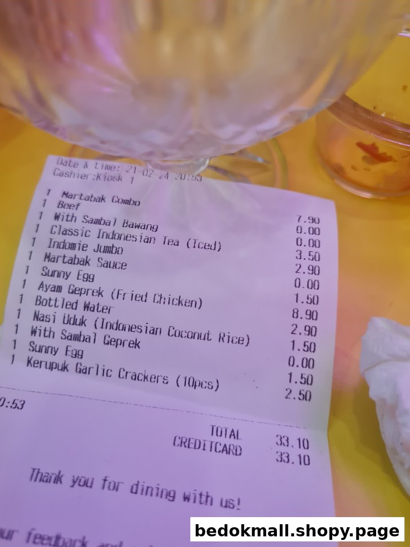 A printed receipt from Smile Martabak Café showing food items and prices.