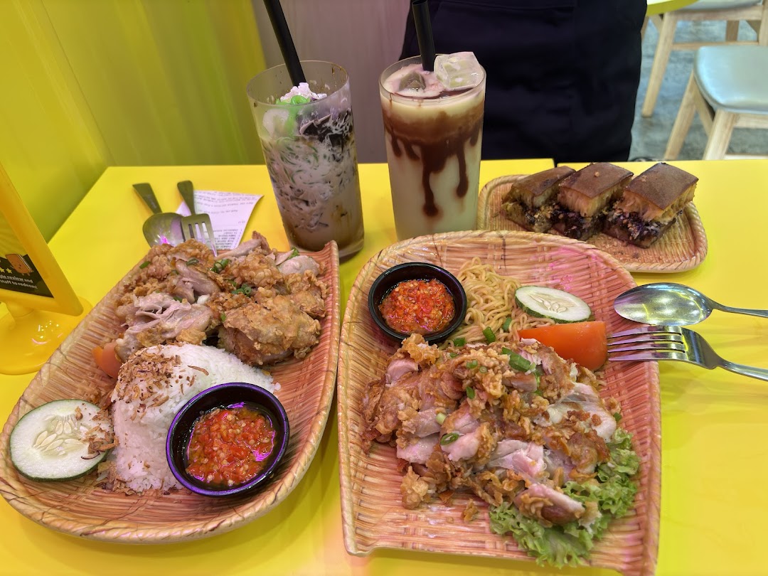 Various food dishes and drinks are displayed on a bright yellow table.