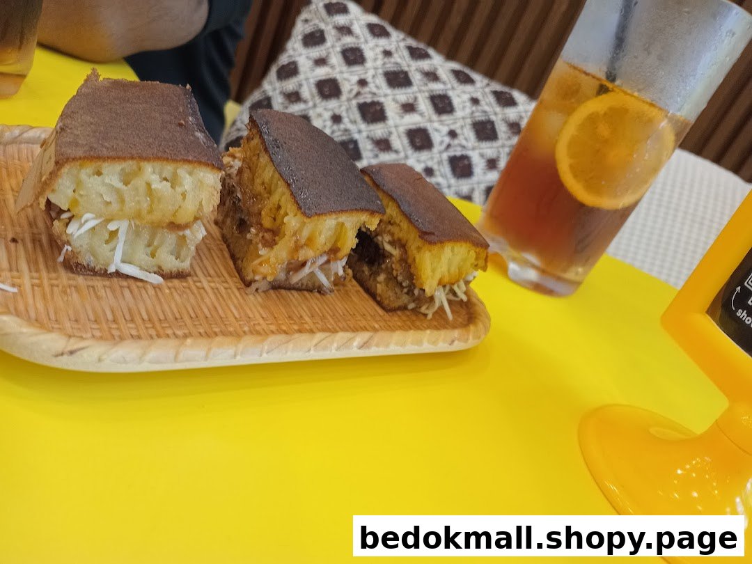 Martabak slices and iced tea on a yellow table.