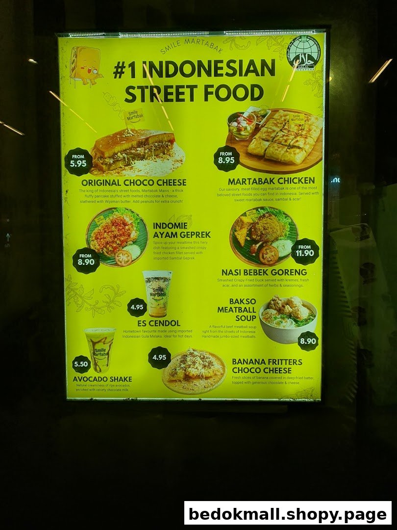 A brightly lit menu board displaying Indonesian street food, drinks, and prices.