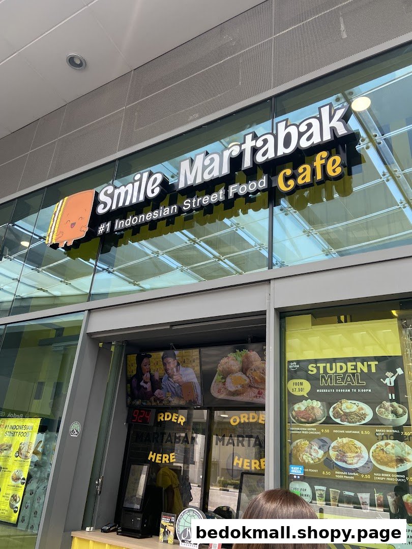 Shop front with large sign, glass windows, and visible menu displays.