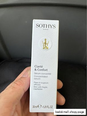 Hand holding a Sothys skincare product box.
