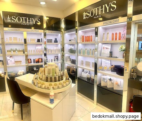 Interior view of a Sothys salon with product displays and a central table.