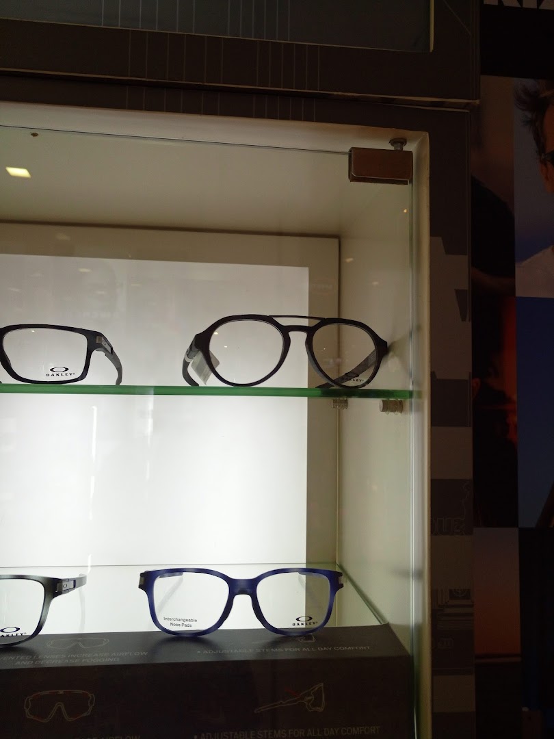 Eyeglasses displayed in a glass cabinet inside the shop.