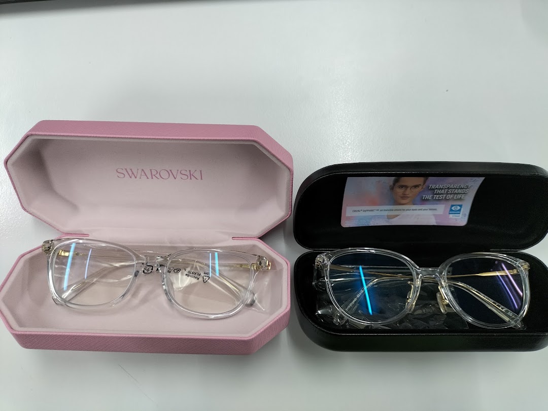 Two pairs of eyeglasses in open cases, one pink and one black.