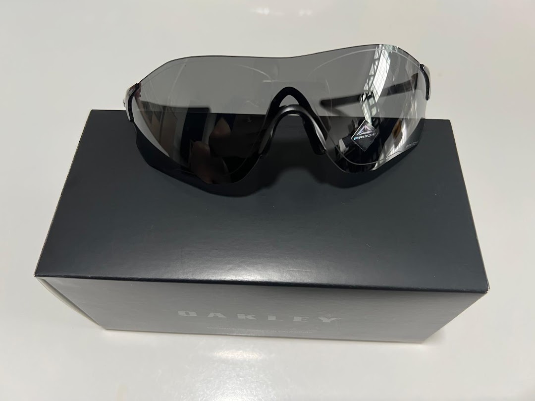 Black sunglasses with reflective lenses resting on a black box.