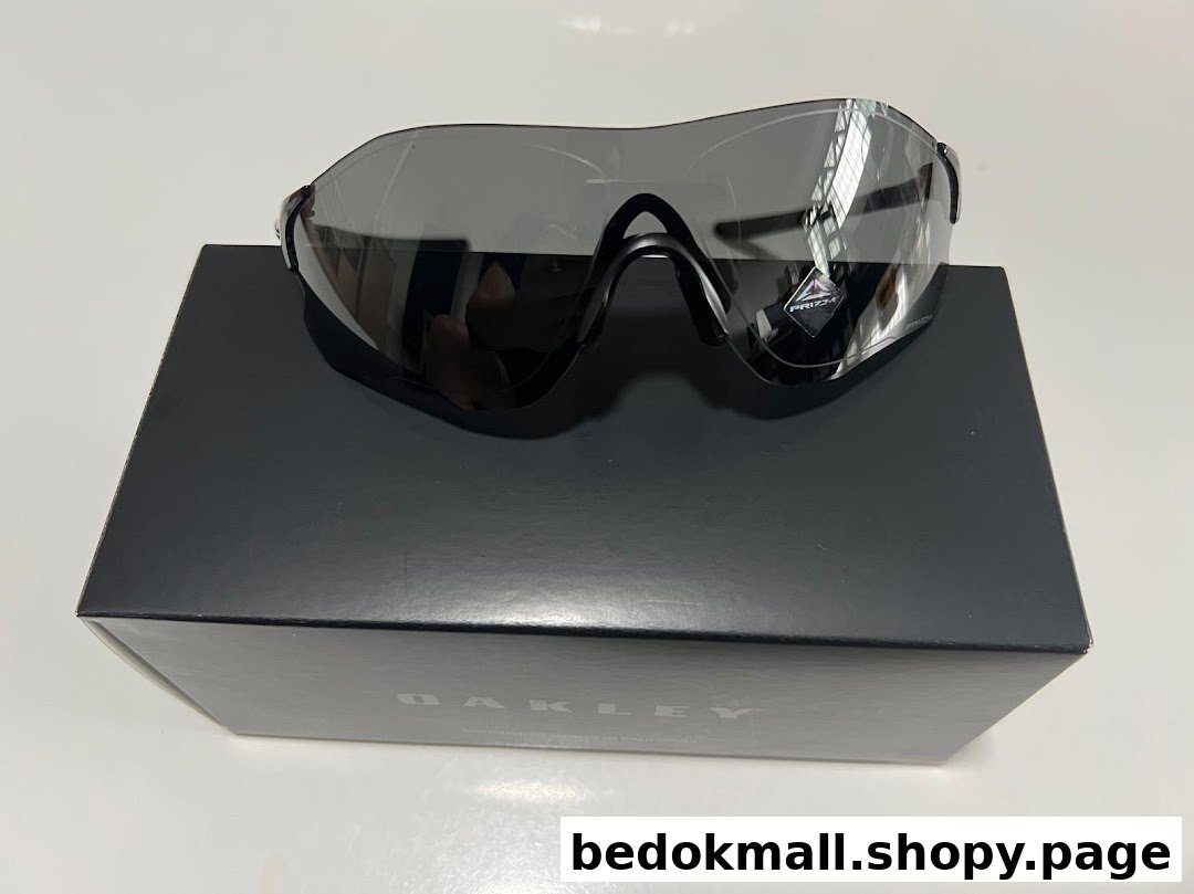 Black sunglasses with reflective lenses resting on a black box.