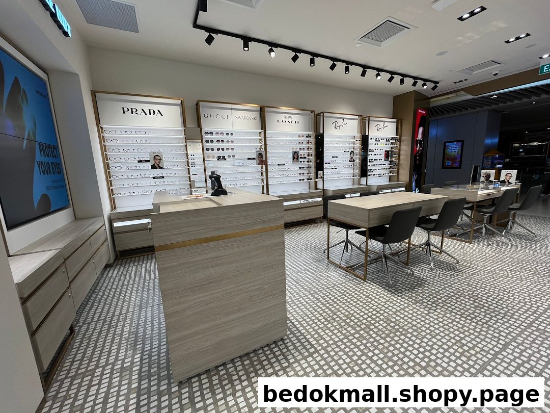 Interior of an optical shop with display shelves of glasses, tables, and chairs.