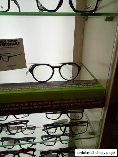 Eyeglasses displayed in a glass cabinet within a retail store.
