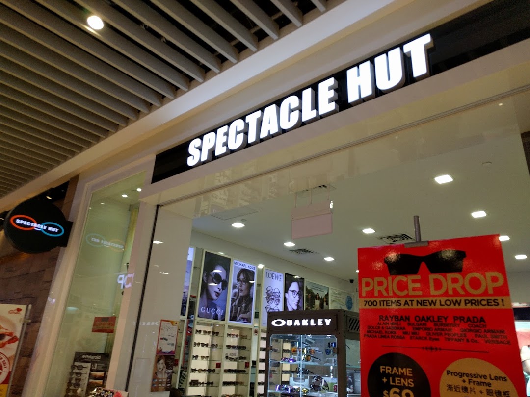 Entrance of Spectacle Hut with its main sign and a promotional banner.