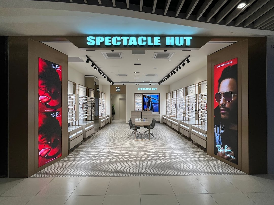 Entrance of an eyewear shop with displays and promotional posters.